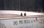 Armed soldiers patrolling the Berlin Wall